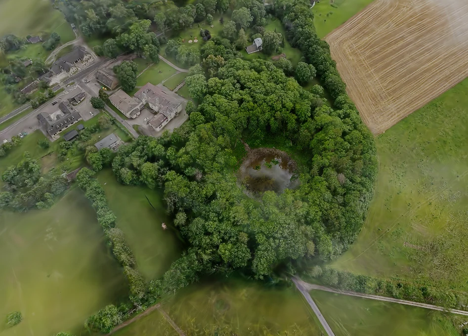 Kaali’s main crater seen within the surrounding landscape and fields.